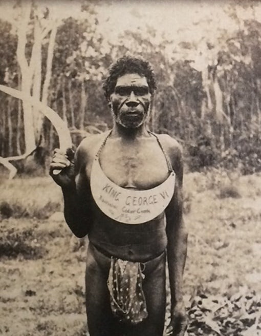 man  wearing  king plate with the words "Cedar Creek"